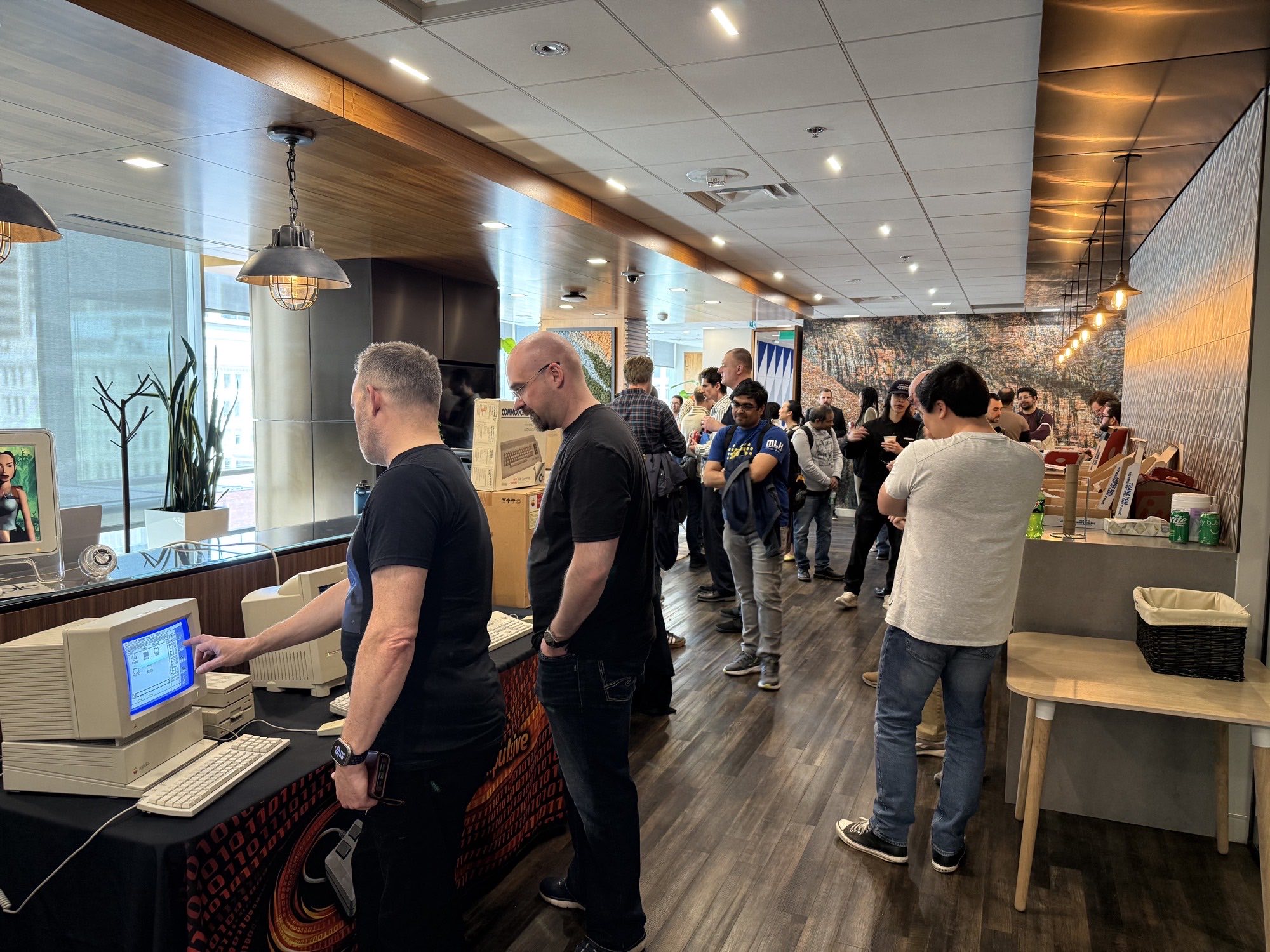 Visitors gathered around the Computer Compulsive booth trying out vintage Apple computers