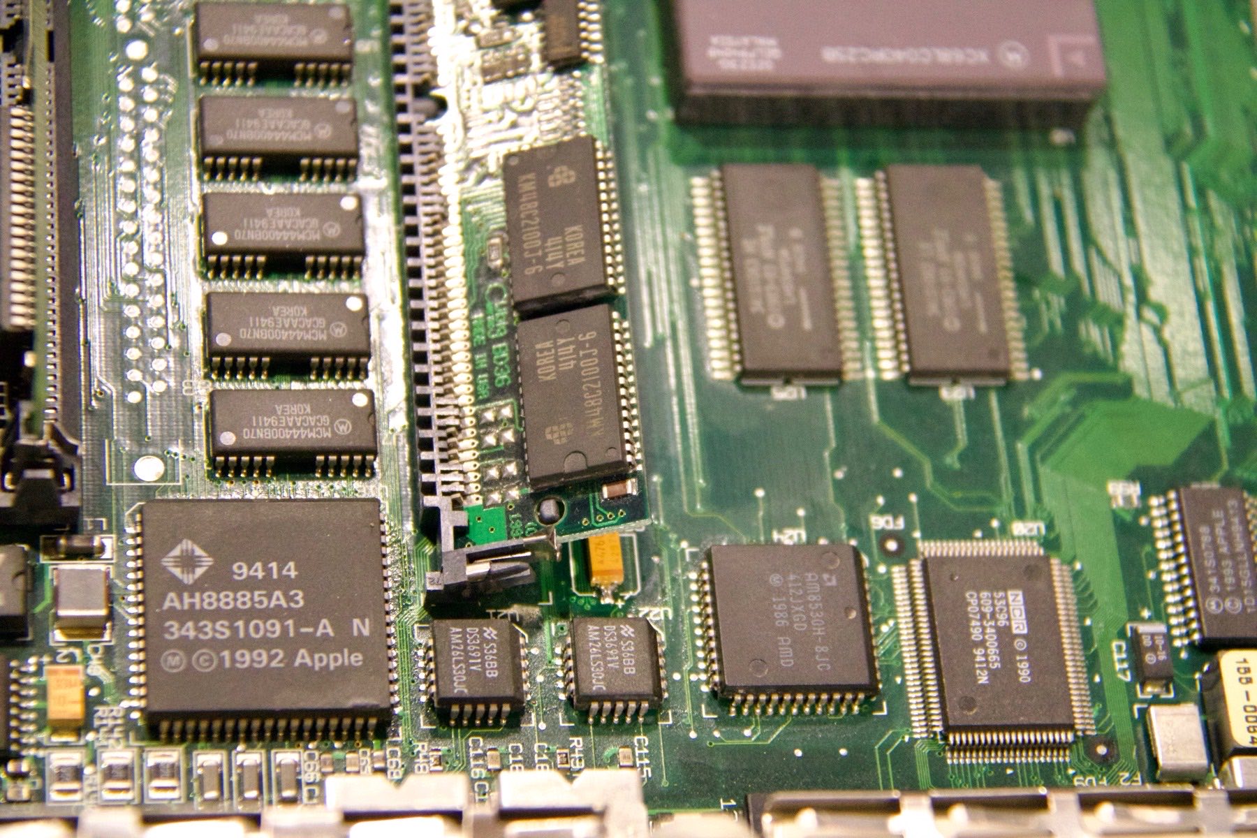 Extreme close-up of a 1992 Apple logic board with surface-mount chips